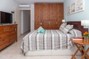 a bedroom with a bed with a teddy bear on it at Apartamento en Cala'n Blanes in Ciutadella