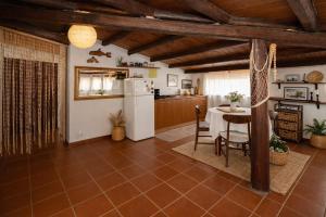 a kitchen and dining room with a table and a refrigerator at Seafront Iconic Lighthouse View Punta Secca in Punta Secca +16 photos