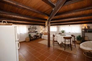 a living room with a table and a bedroom at Seafront Iconic Lighthouse View Punta Secca in Punta Secca