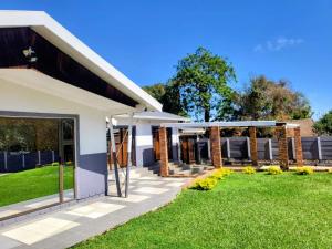 a rendering of a house with a lawn at Golf Road Guesthouse in Pietermaritzburg