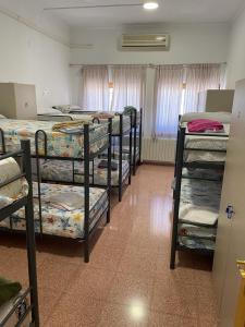 a room with a bunch of bunk beds at Hostel Rural David Broncano in Orcera