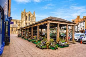 a flower market with flowers in a building at Hexham Town Centre, Market Place View in Hexham
