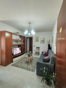 a living room with a couch and a table at "Da Carla e Sandro"- Appartamento con parcheggio privato in Quartucciu