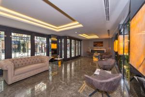 a living room with a couch and chairs at Hotel Genova Istanbul Old City in Istanbul