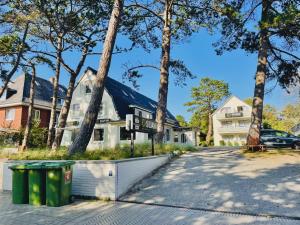a white house with trees in front of it at Hotel Silvana in Böhl