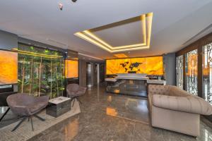 a living room with a couch and a piano at Hotel Genova in Istanbul