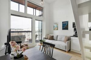 a living room with a couch and a table at Sonetti - Metso library apartments Come in! in Tampere