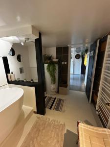 a bathroom with a tub and a toilet in a room at Pause confortable, escapade culturelle in Caen