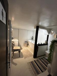a bathroom with a bath tub and a sink at Pause confortable, escapade culturelle in Caen