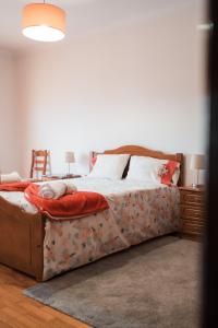 a large bed in a bedroom with a table and chair at Casa do Rodrigo in Mondim de Basto