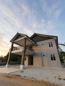 a large house with a balcony on top of it at UZ Jerteh Inn in Jertih