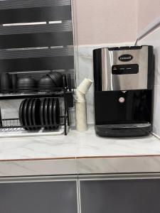 a coffee maker sitting on top of a counter at UZ Jerteh Inn in Jertih