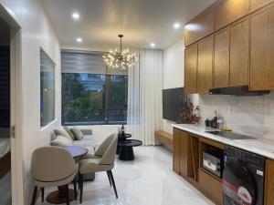 a kitchen with a couch and a table and chairs at Sunrise Apartments in Xóm Niêm