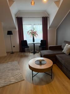 a living room with a couch and a table at Apartament Umami in Pniewy