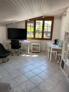 an office with a desk and two chairs and a table at Tierparkunterkunft in Goldau +4 photos