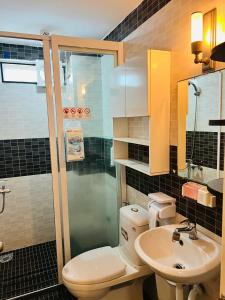 a bathroom with a toilet and a sink and a shower at Da Nang Sleepbox & Dorm in Danang