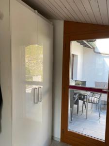 a sliding glass door leading to a patio with a table at Tierparkunterkunft in Goldau