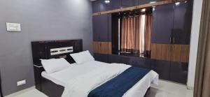 a small bedroom with a bed and a window at 2 BHK All AC Rooms Solapur Home Stay By Stay Nestura in Solapur