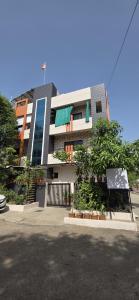 a building with a sign in front of it at 2 BHK All AC Rooms Solapur Home Stay By Stay Nestura in Solapur