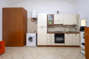 a kitchen with a refrigerator and a washing machine at Dimora Dina Guglionesi in Guglionesi
