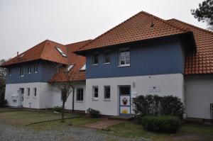 a house with a blue and white house at Gaestehaus-W-13 in Prerow +4 photos