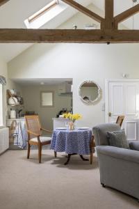 a living room with a table with flowers on it at The Hat Shop in Hexham +9 photos