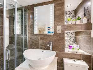 a bathroom with a sink and a glass shower at Hexham Town Centre, Market Place View in Hexham +39 photos