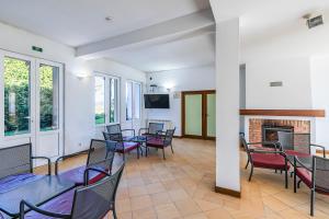 a room with tables and chairs and a fireplace at HI Ofir – Pousada de Juventude in Esposende