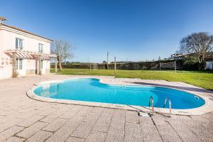 a swimming pool in the middle of a yard at HI Ofir – Pousada de Juventude in Esposende