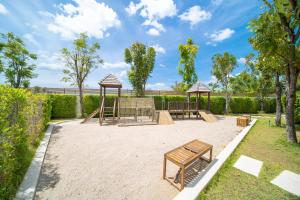a playground with benches and gazebos in a park at Mouana Breeze Mai Khao VIP 4-bedroom Pool Villa 9911 in Phuket