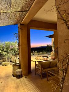 a living room with a couch on a patio at Villa Kela Serene in Marrakesh