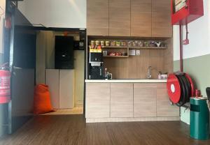 a small kitchen with a refrigerator and a sink at Room V Jalan Jenang by SECOMS in Batu Pahat