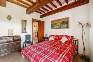 a bedroom with a red bed and a blue chair at Collazzone - "Il Tramonto" casale con piscina in Collazzone +38 photos