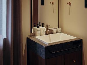 a bathroom with a sink and a mirror at illi Hotels Lume Shibuya in Tokyo