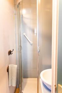 a shower with a glass door next to a sink at Les Colombes in Saint-Tricat +14 photos