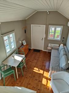 a living room with a couch and a table at Haus Alva in Ronneby +10 photos