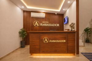 a hotel ambassador sign on a wall in a lobby at HOTEL AMBASSADOR SUKHNA LaKE in Chandīgarh