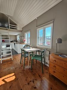 a kitchen with a table and chairs in a room at Haus Alva in Ronneby