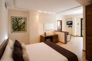 a hotel room with a bed and a bathroom at Zia Nì Boutique Suites in Peschici
