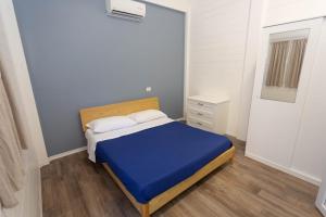 a small bedroom with a blue bed and a dresser at Aquarius Policoro in Policoro +5 photos