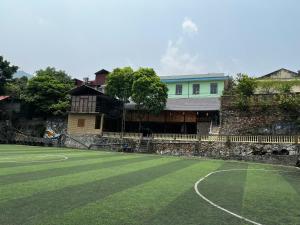 a tennis court in front of a house at Rocky Eco House in Na Hang