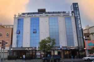 a large building with glass windows on a street at كلود فيو in Abha