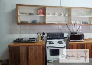 a kitchen with a stove and a counter top at Steytlerville Karoo Backpackers in Steytlerville