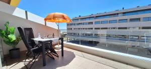 a table on the balcony of a building at Ferreirinhas - Beach House in Vila do Conde