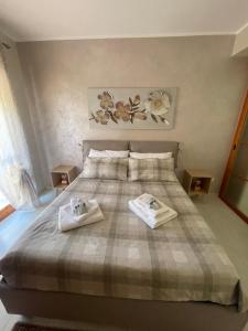 a bedroom with a bed with two towels on it at Mirabilia in Maratea