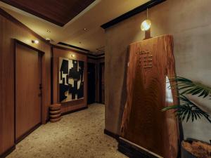 a hallway with a room with a wooden wall at illi Hotels Lume Shibuya in Tokyo
