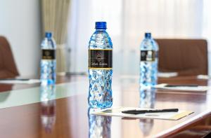 two bottles of water on a table with a pen at Sebai Luxury Suites in Naivasha