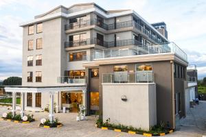 a large white building with a balcony at Sebai Luxury Suites in Naivasha