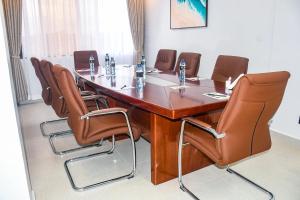 a conference room with a wooden table and leather chairs at Sebai Luxury Suites in Naivasha