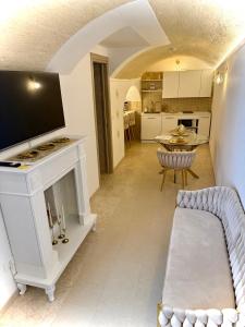a living room with a couch and a fireplace at Borgo Antico in Grottaglie +44 photos